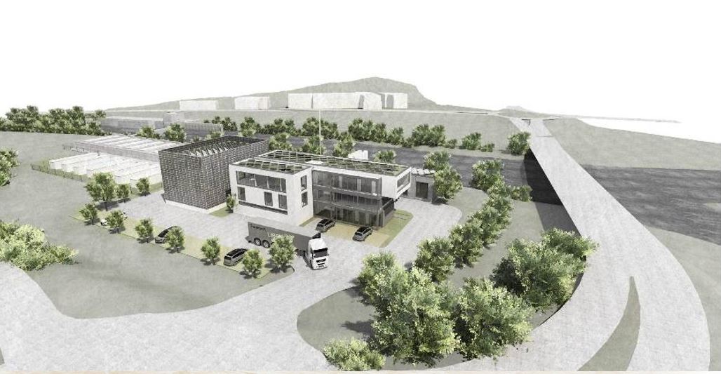 Das H2 Forschungszentrum nach Abschluss der Baumaßnahmen. Ein großes modernes Gebäude mit einer breiten Zufahrt für LKW und Fahrzeuge